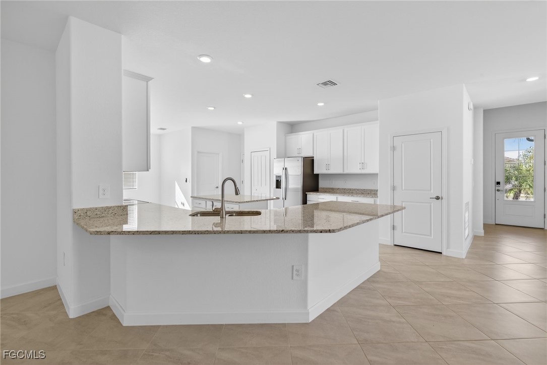 17364 Walnut Run Drive Alva, FL 33920 - Photo 24 of 50 a large kitchen with stainless steel appliances a sink a counter top space and cabinets