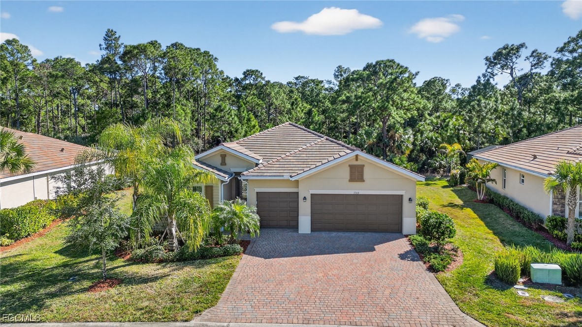 17364 Walnut Run Drive Alva, FL 33920 - Photo 3 of 50 front view of a house with a yard