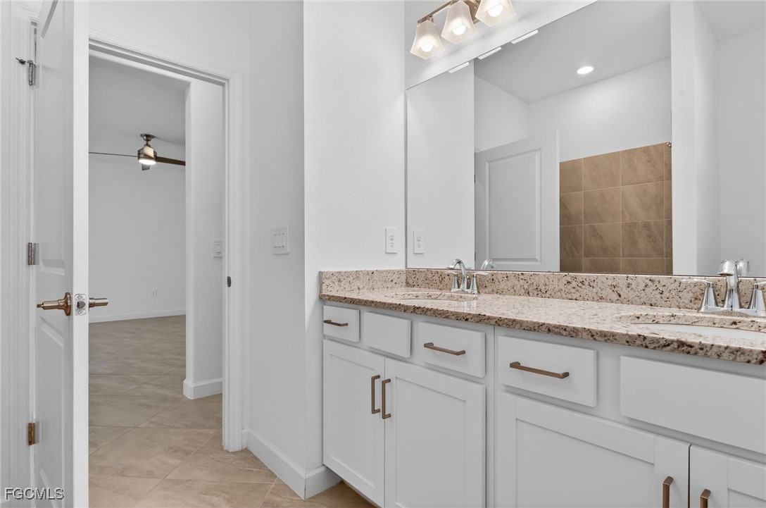 17364 Walnut Run Drive Alva, FL 33920 - Photo 31 of 50 a bathroom with a granite countertop sink and a mirror