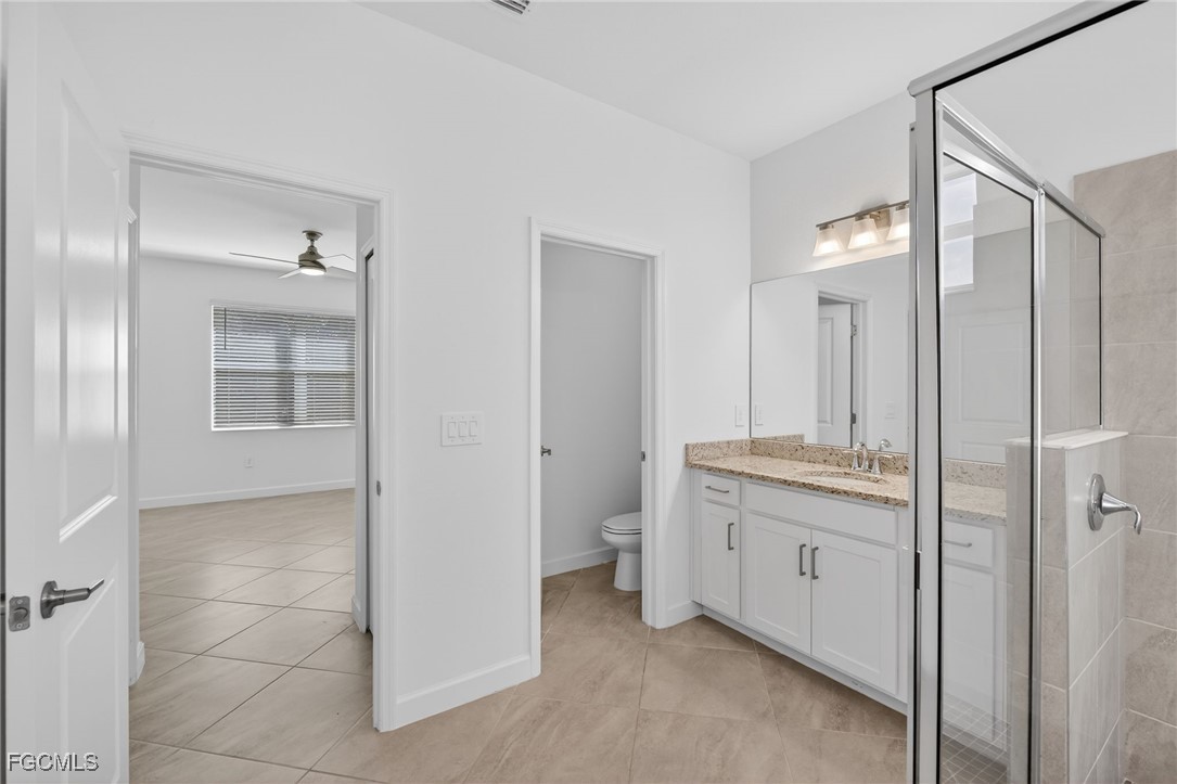 17364 Walnut Run Drive Alva, FL 33920 - Photo 38 of 50 a bathroom with a granite countertop sink a toilet and shower