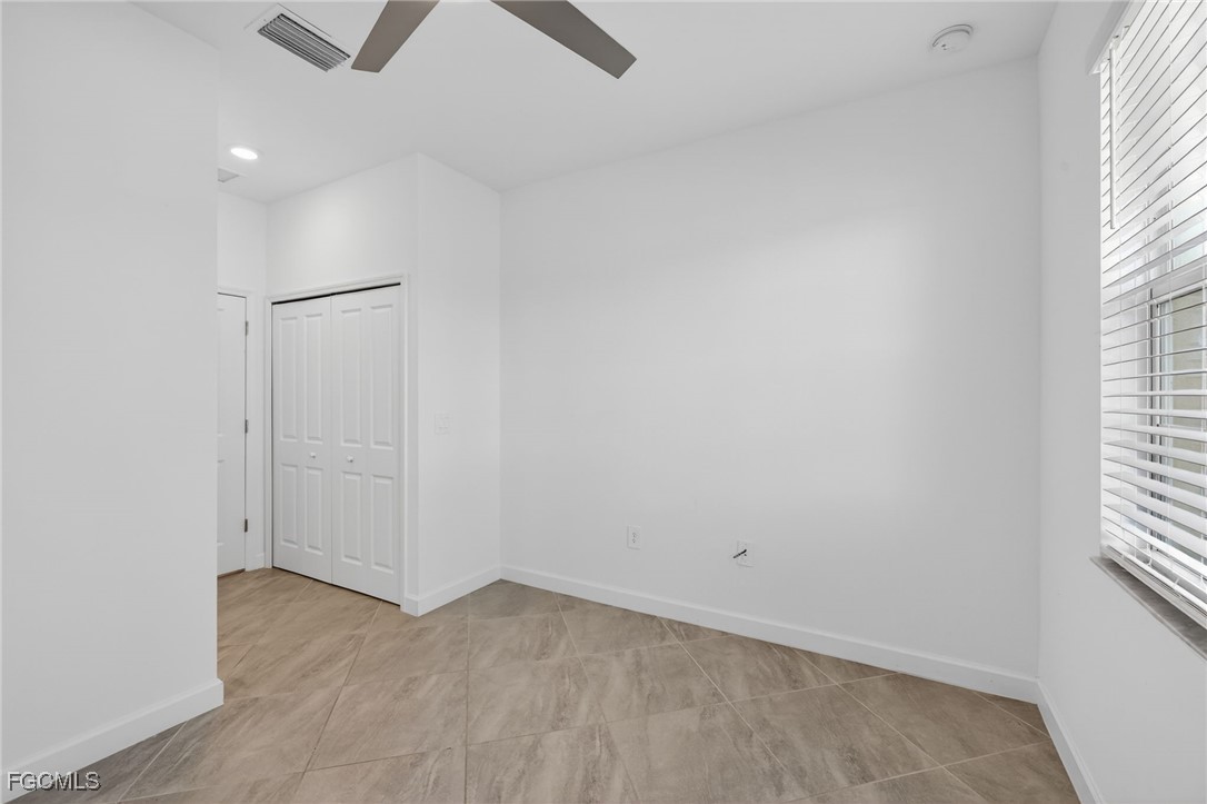 17364 Walnut Run Drive Alva, FL 33920 - Photo 43 of 50 an empty room with a window and ceiling fan