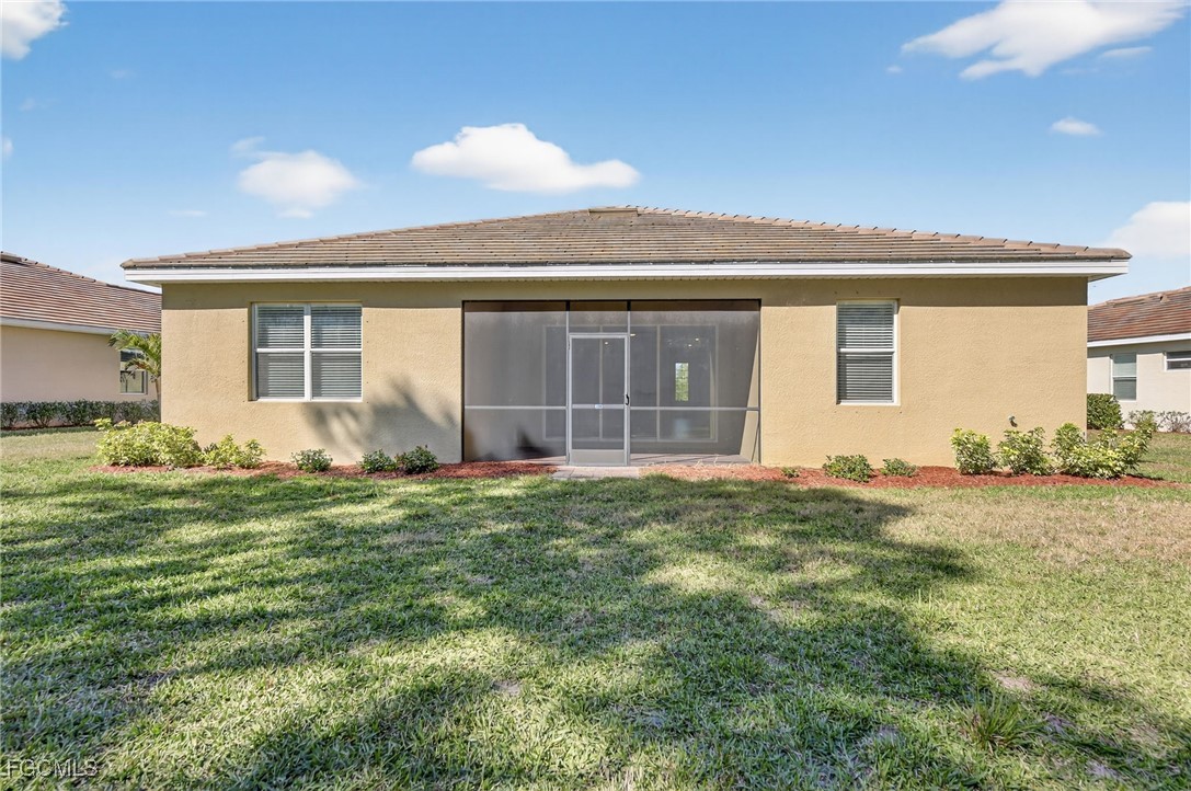 17364 Walnut Run Drive Alva, FL 33920 - Photo 48 of 50 a front view of a house with a garden
