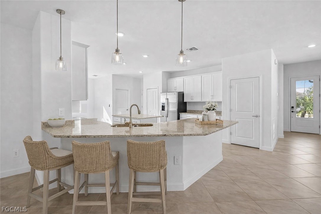 17364 Walnut Run Drive Alva, FL 33920 - Photo 7 of 50 a kitchen with stainless steel appliances granite countertop a sink and a refrigerator
