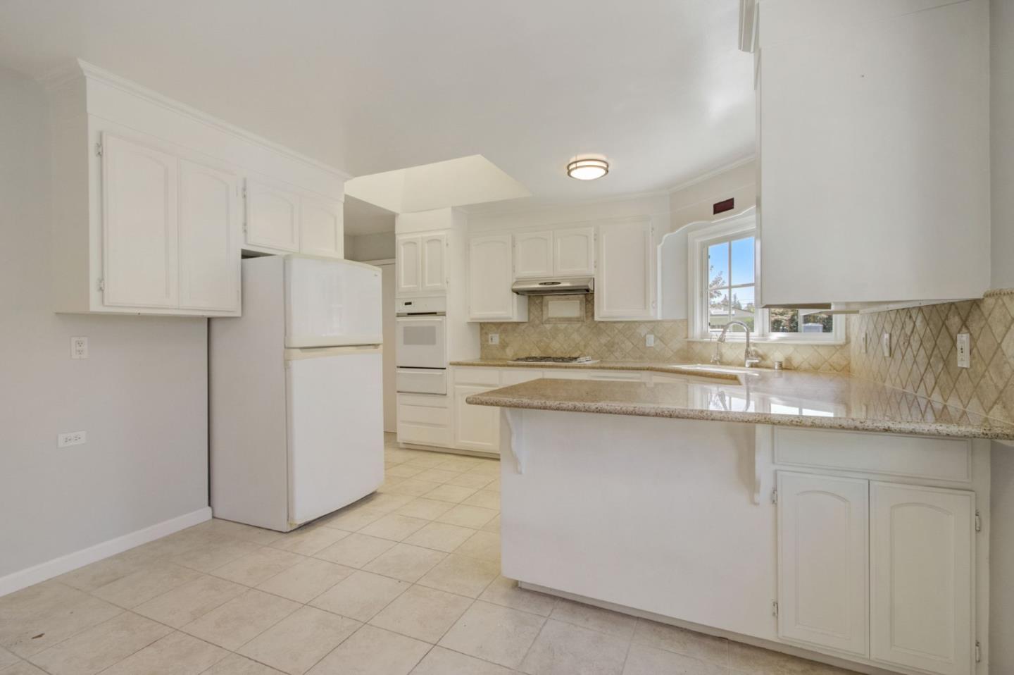 613 North Central Avenue Campbell, CA 95008 - Photo 16 of 66 a kitchen with white cabinets and refrigerator
