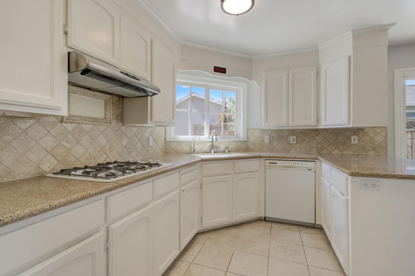 613 North Central Avenue Campbell, CA 95008 - Photo 18 of 66 a kitchen with granite countertop a sink a stove and cabinets