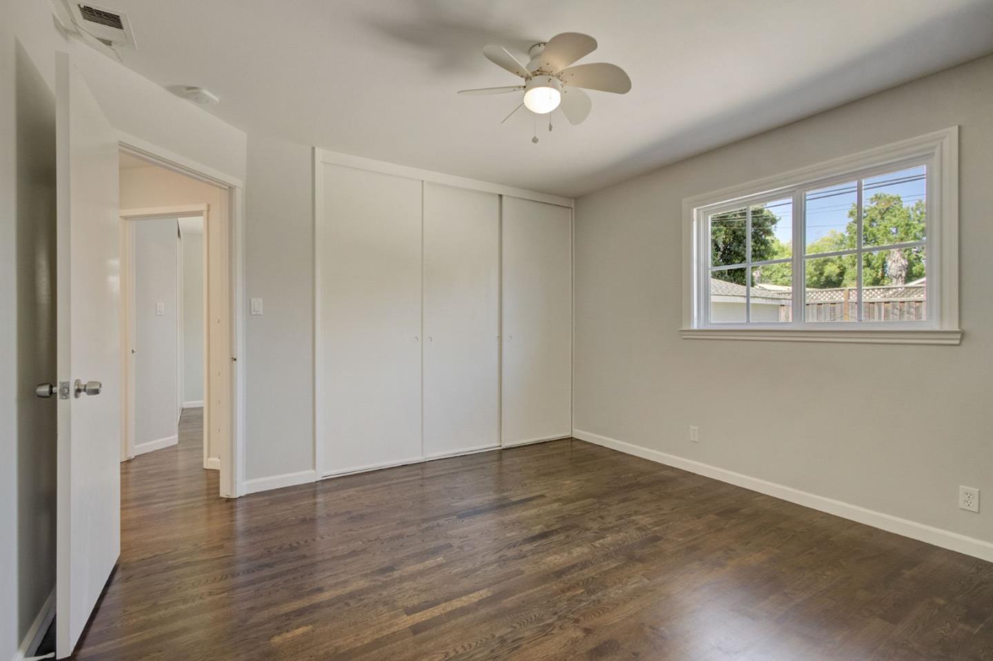 613 North Central Avenue Campbell, CA 95008 - Photo 36 of 66 a view of an empty room with a window and wooden floor