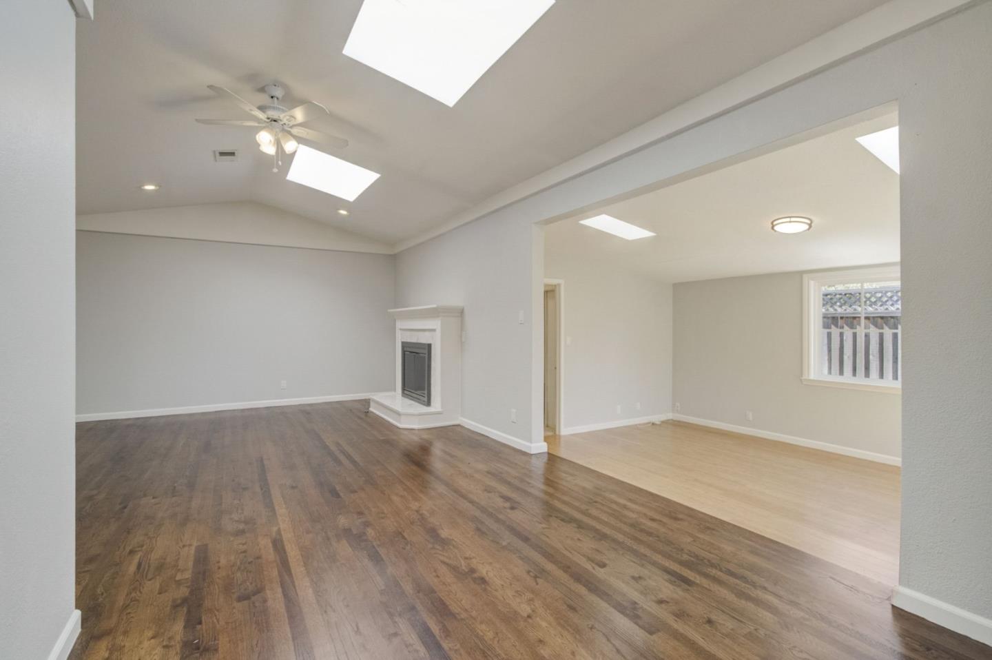 613 North Central Avenue Campbell, CA 95008 - Photo 10 of 66 an empty room with wooden floor and windows