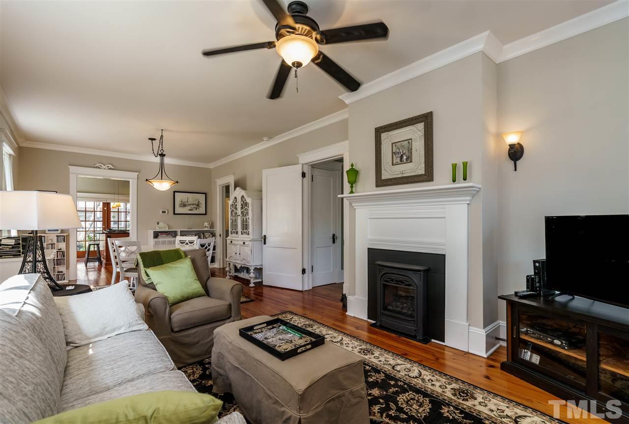 617 Elm Street Raleigh, NC 27604 - Photo 3 of 26 a living room with furniture a flat screen tv and a fireplace