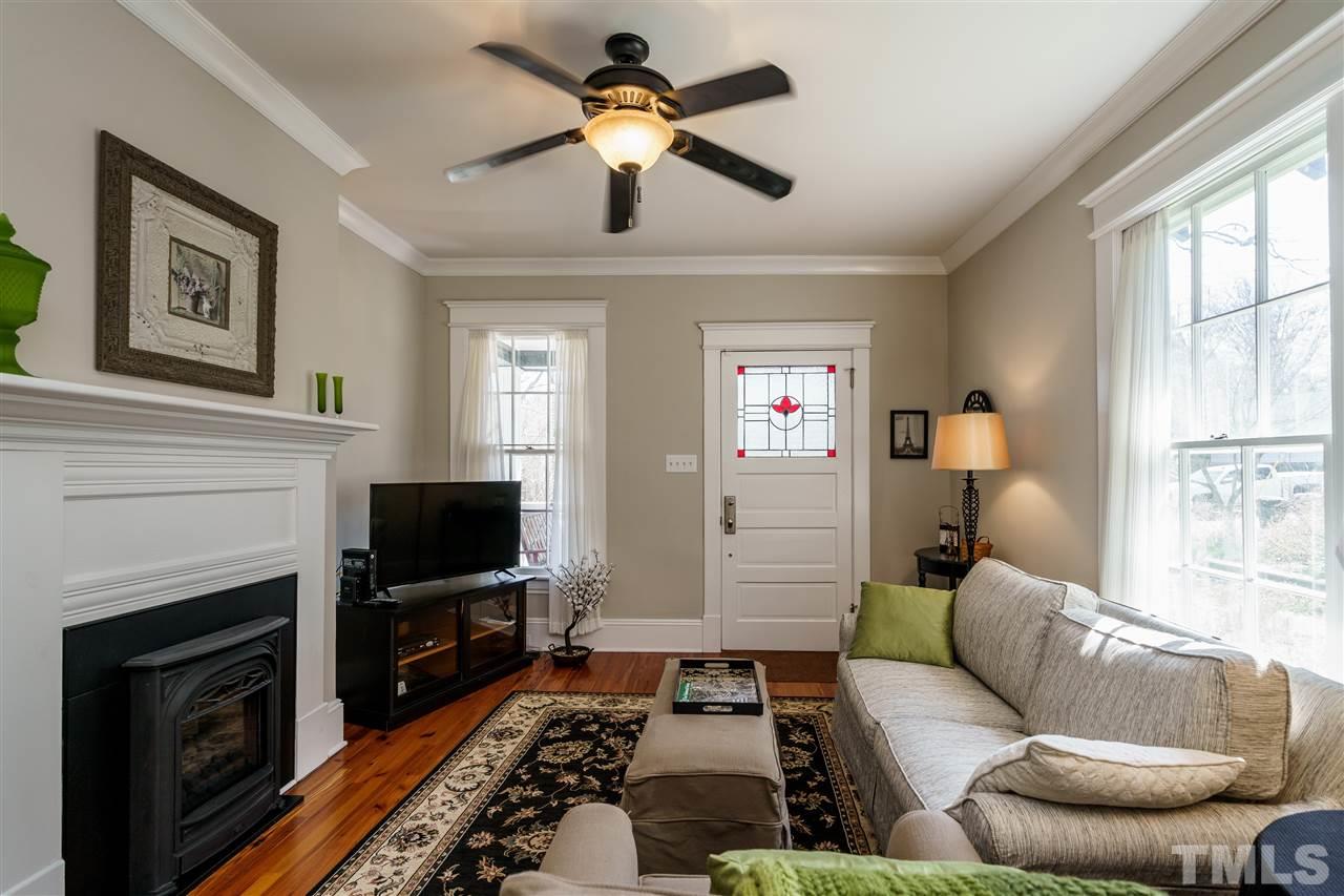 617 Elm Street Raleigh, NC 27604 - Photo 4 of 26 a living room with furniture a flat screen tv and a fireplace