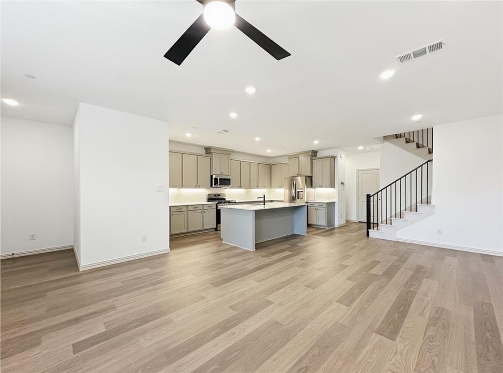 2837 Bluejack Road McKinney, TX 75071 - Photo 2 of 40 a view of kitchen with wooden floor and electronic appliances