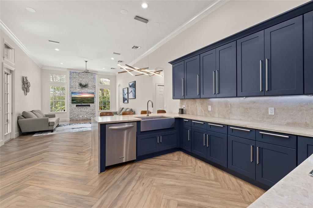 8351 Bowden Way Windermere, FL 34786 - Photo 7 of 71 a large kitchen with wooden floors and stainless steel appliances