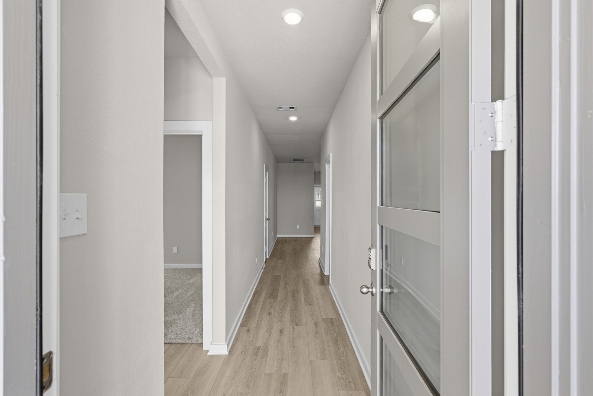 3627 Atlas Pt Lane Angleton, TX 77515 - Photo 9 of 36 a view of a hallway with wooden floor and staircase