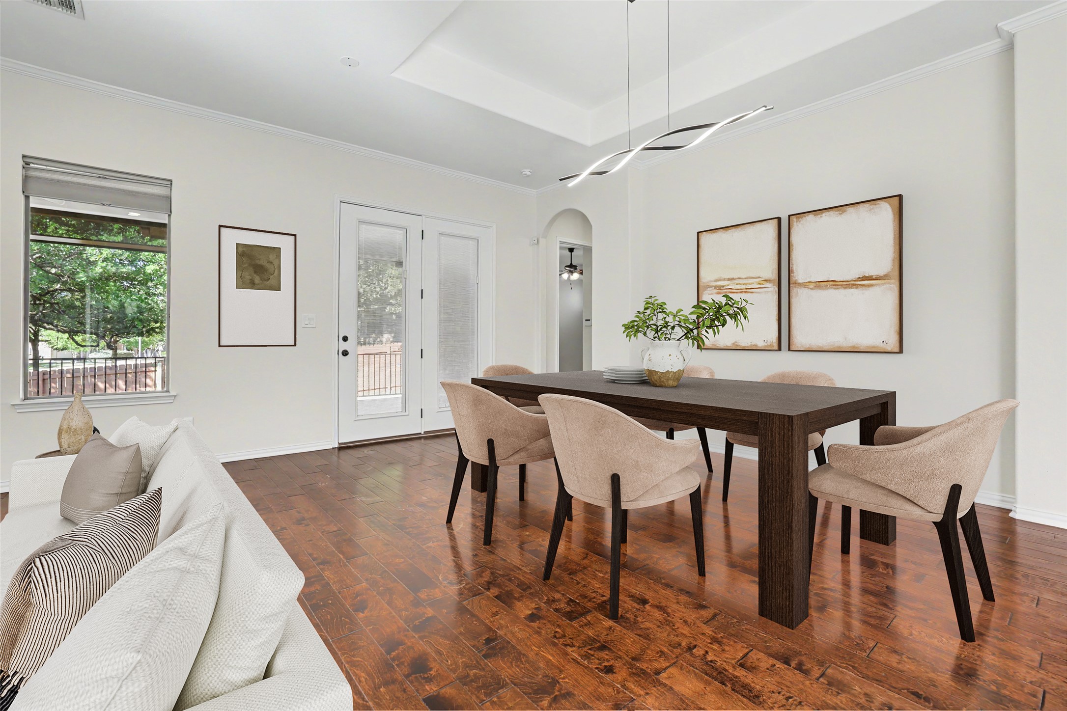 1020 Winding Way Drive Georgetown, TX 78628 - Photo 8 of 32 Dining space with dark wood-style flooring, arched walkways, ornamental molding, and a tray ceiling