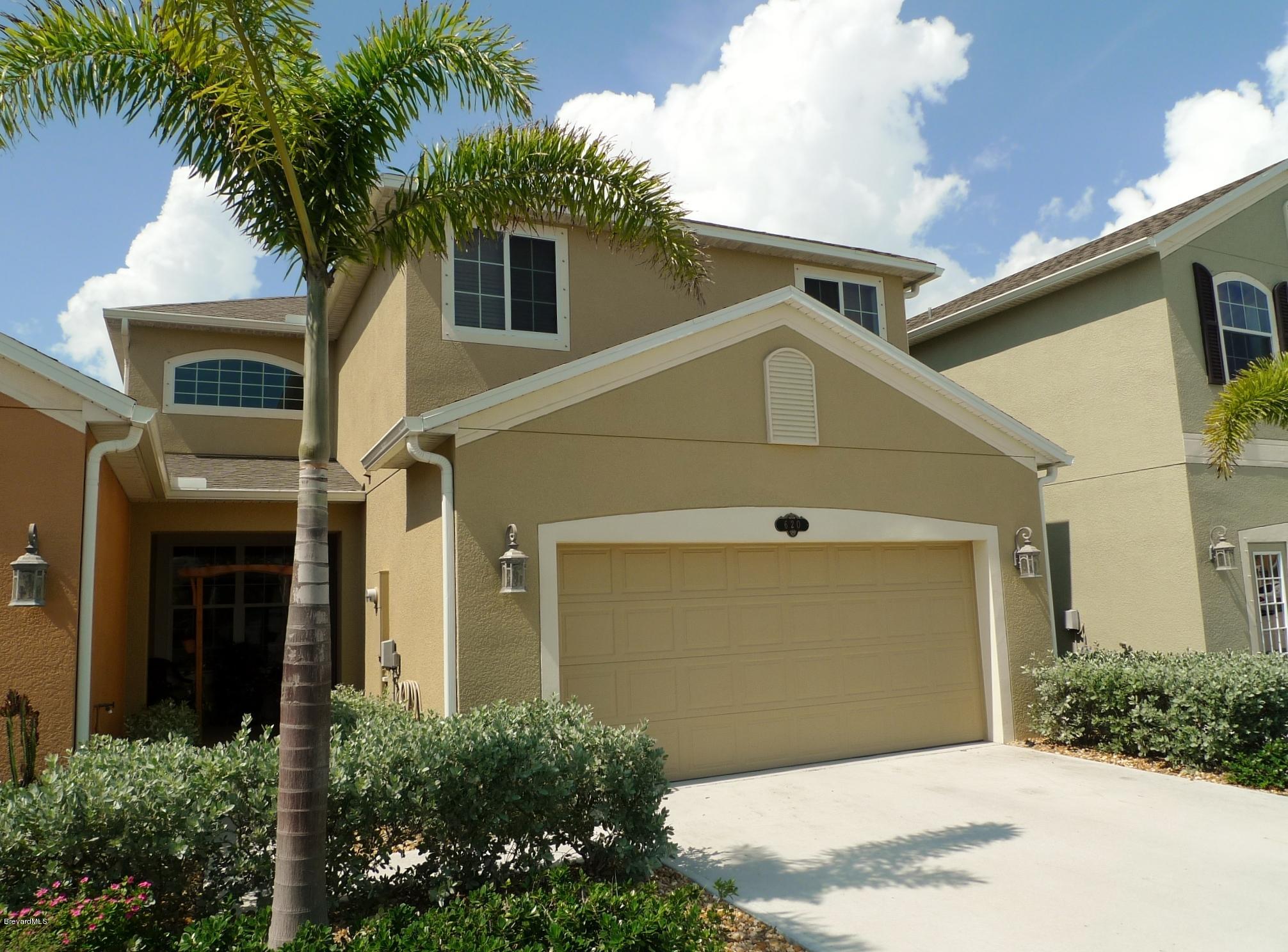 620 Bismarck Way Indialantic, FL 32903 - Photo 1 of 14 a view of a white house with a large windows