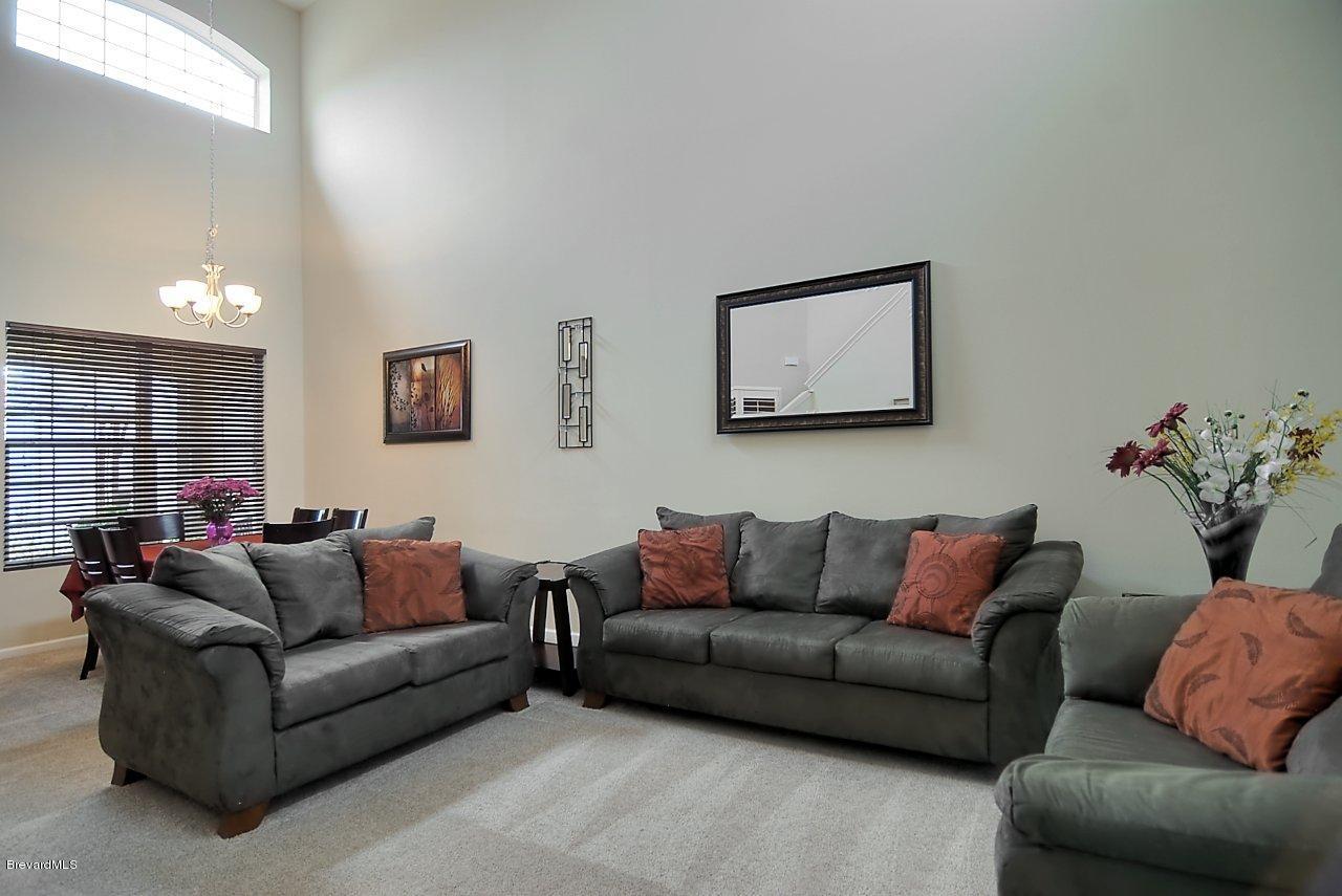 620 Bismarck Way Indialantic, FL 32903 - Photo 7 of 14 a living room with furniture and a couch