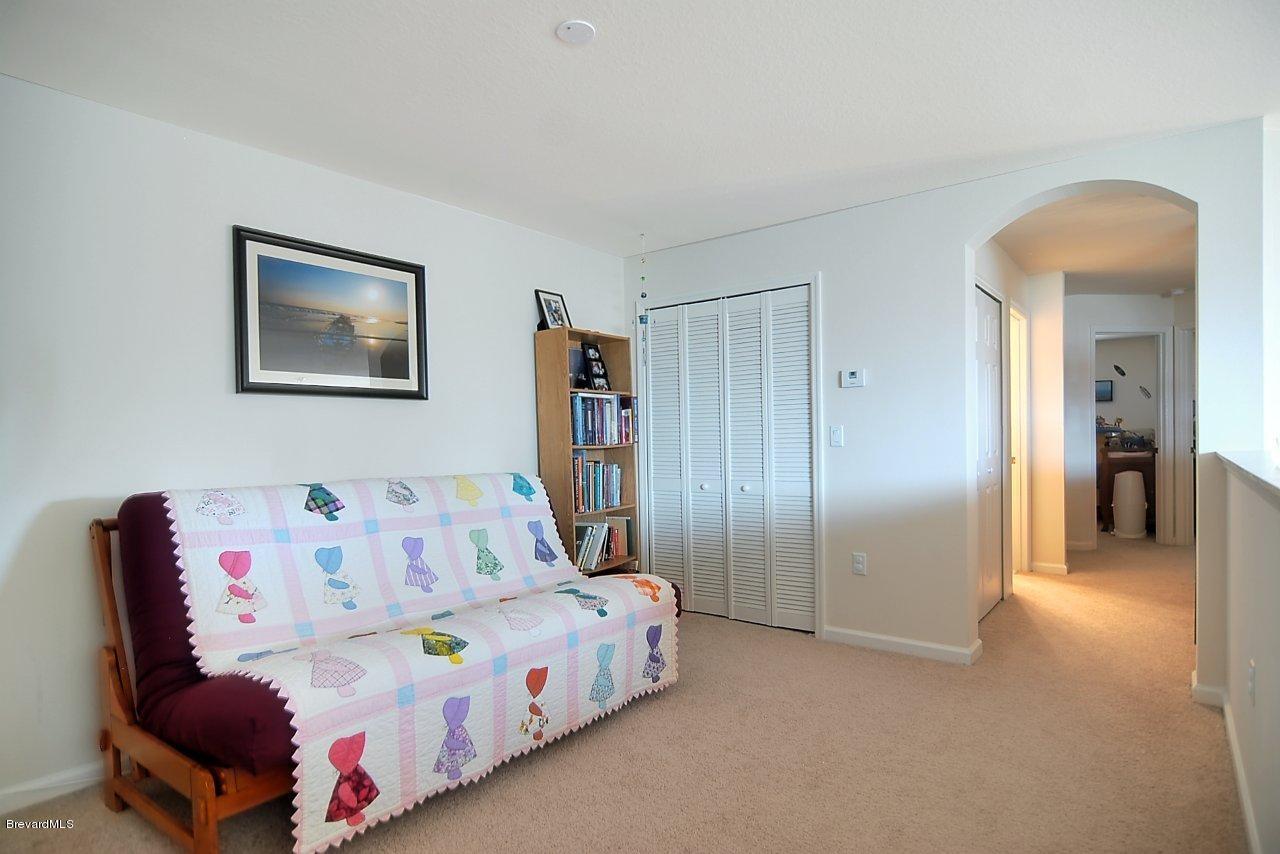 620 Bismarck Way Indialantic, FL 32903 - Photo 8 of 14 a bedroom with a bed and a painting on the wall
