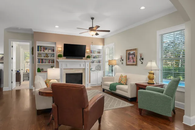 a living room with furniture a flat screen tv and a fireplace