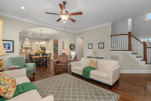 a living room with furniture potted plant and a chandelier