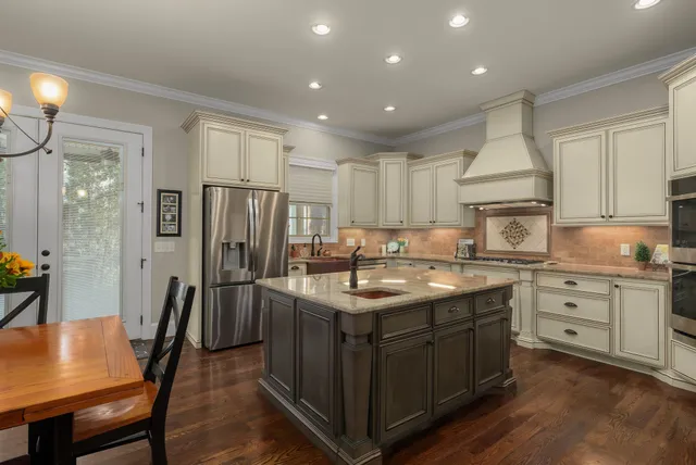 a kitchen with stainless steel appliances granite countertop a sink stove and refrigerator