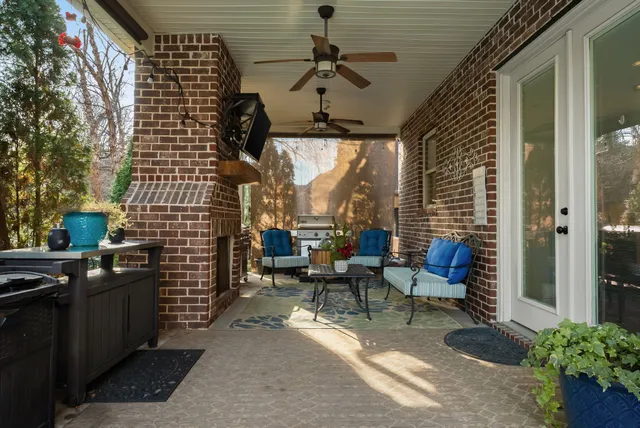 a view of a patio with chairs and potted plants