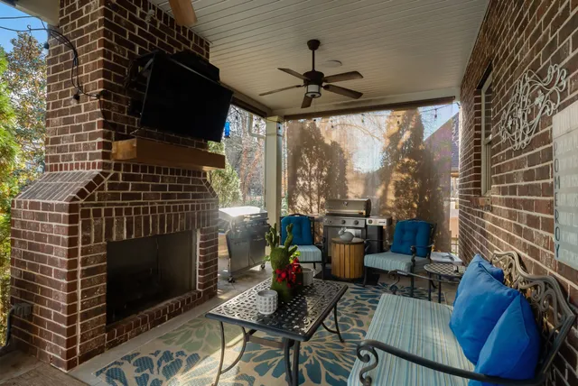 a living room with furniture a fireplace and a floor to ceiling window