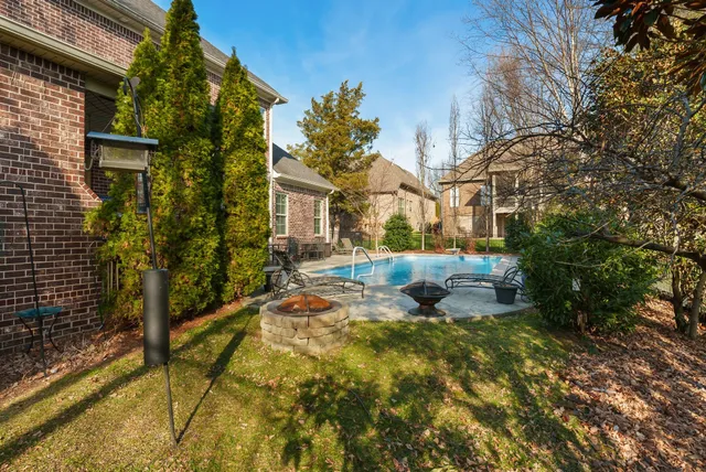 a backyard of a house with table and chairs