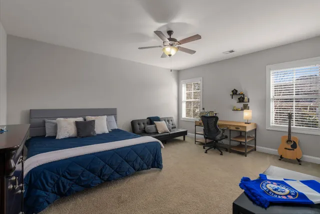 a bedroom with bed couch and window