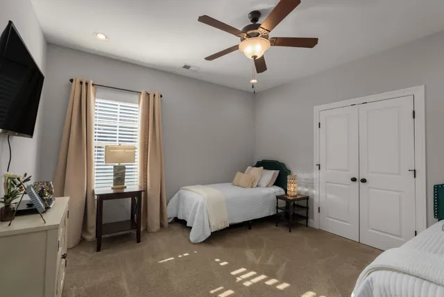 a room with a bed a flat screen tv and a window