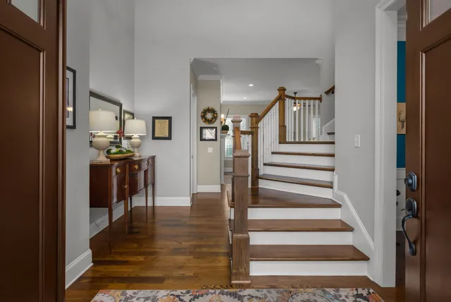 a view of entryway and hall with wooden floor