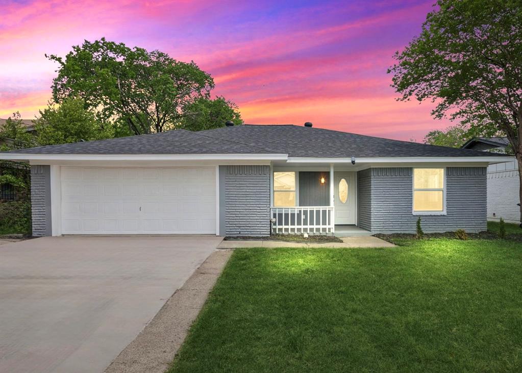 Welcome home! View of front of the home, driveway & two car garage. 