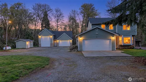 a view of a house with a yard and tree s