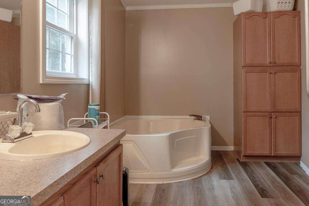 714 Yates Road Bowdon, GA 30108 - Photo 13 of 28 a bathroom with a tub sink and mirror