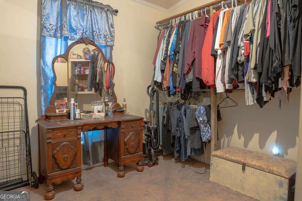 714 Yates Road Bowdon, GA 30108 - Photo 18 of 28 a view of walk in closet with clothes