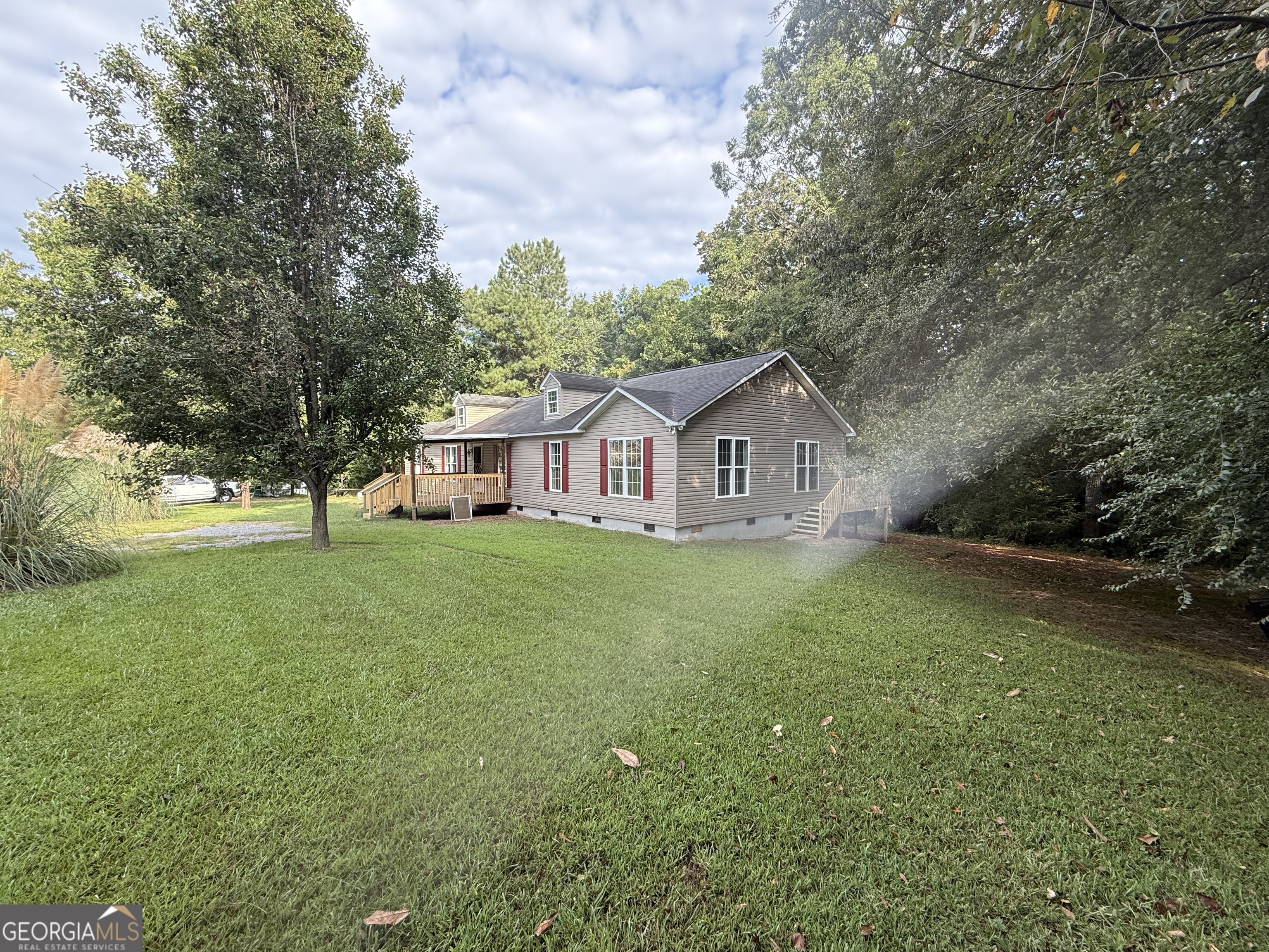714 Yates Road Bowdon, GA 30108 - Photo 2 of 28 a front view of a house with garden