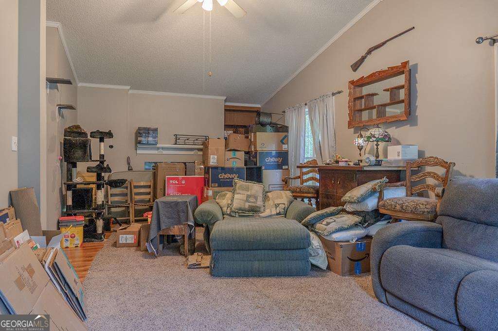 714 Yates Road Bowdon, GA 30108 - Photo 23 of 28 a living room with furniture and a flat screen tv