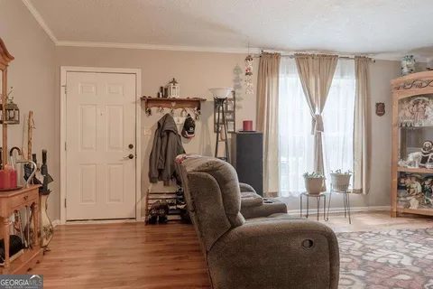 a view of a livingroom with furniture and a window