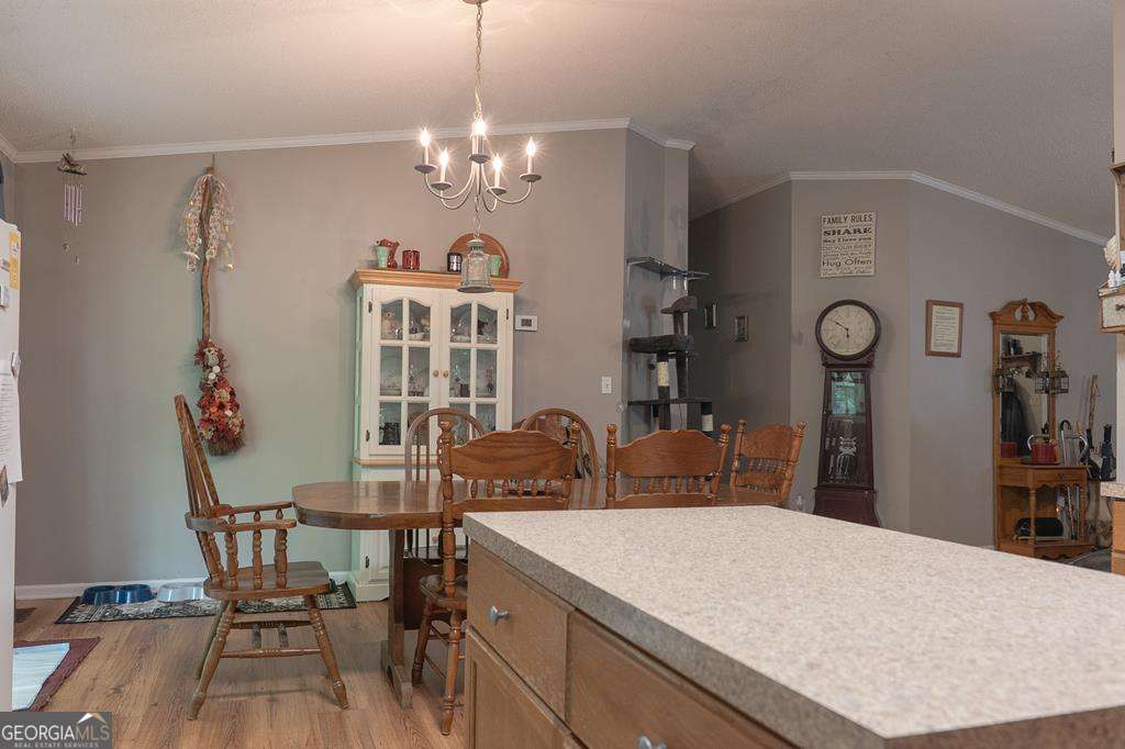 714 Yates Road Bowdon, GA 30108 - Photo 7 of 28 a view of a dining room with furniture and chandelier