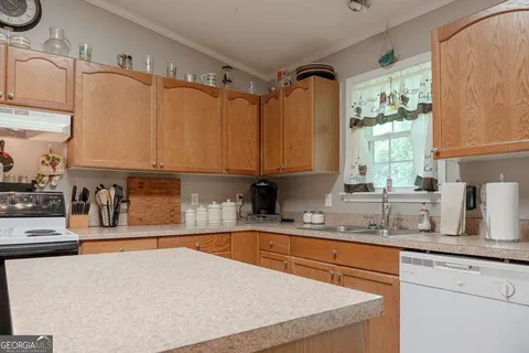 a kitchen with stainless steel appliances granite countertop a sink a stove and a microwave