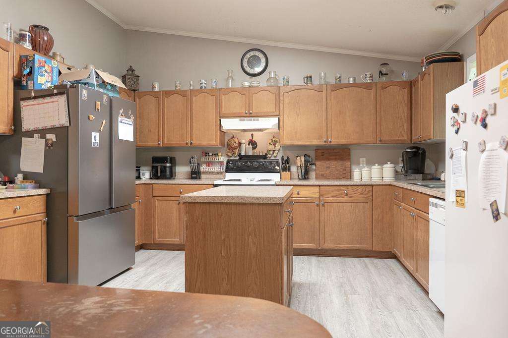 714 Yates Road Bowdon, GA 30108 - Photo 10 of 28 a kitchen with stainless steel appliances granite countertop a refrigerator sink and cabinets