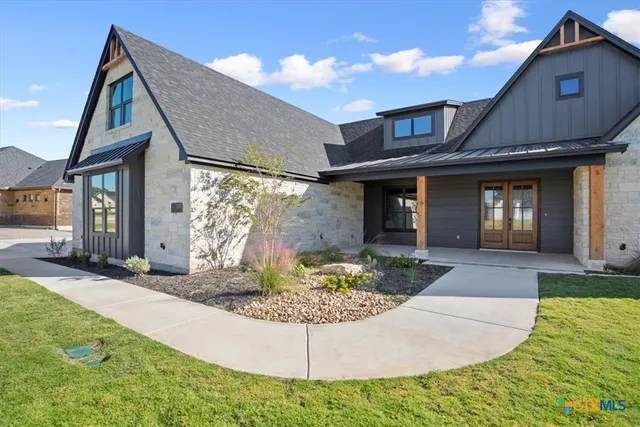a front view of a house with garden