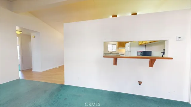 a view of a bedroom with wooden floor and cabinet