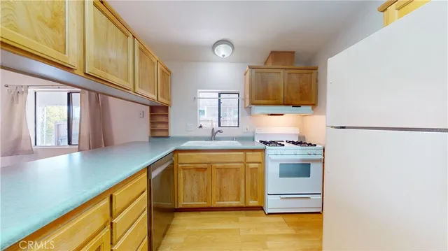 a kitchen with stainless steel appliances granite countertop a sink and a stove