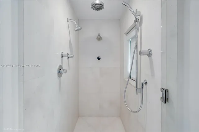 a bathroom with bathtub and windows