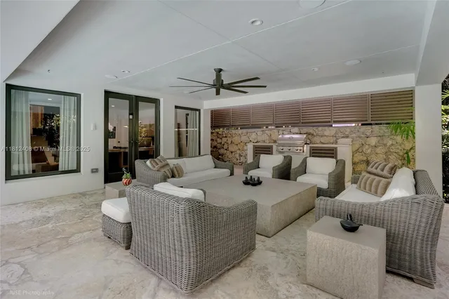 a view of a patio with table and chairs and potted plants