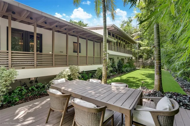 a bathroom with a double vanity sink mirror and bathtub
