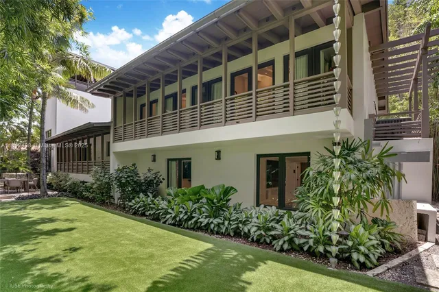 a bedroom with a large bed and a large window