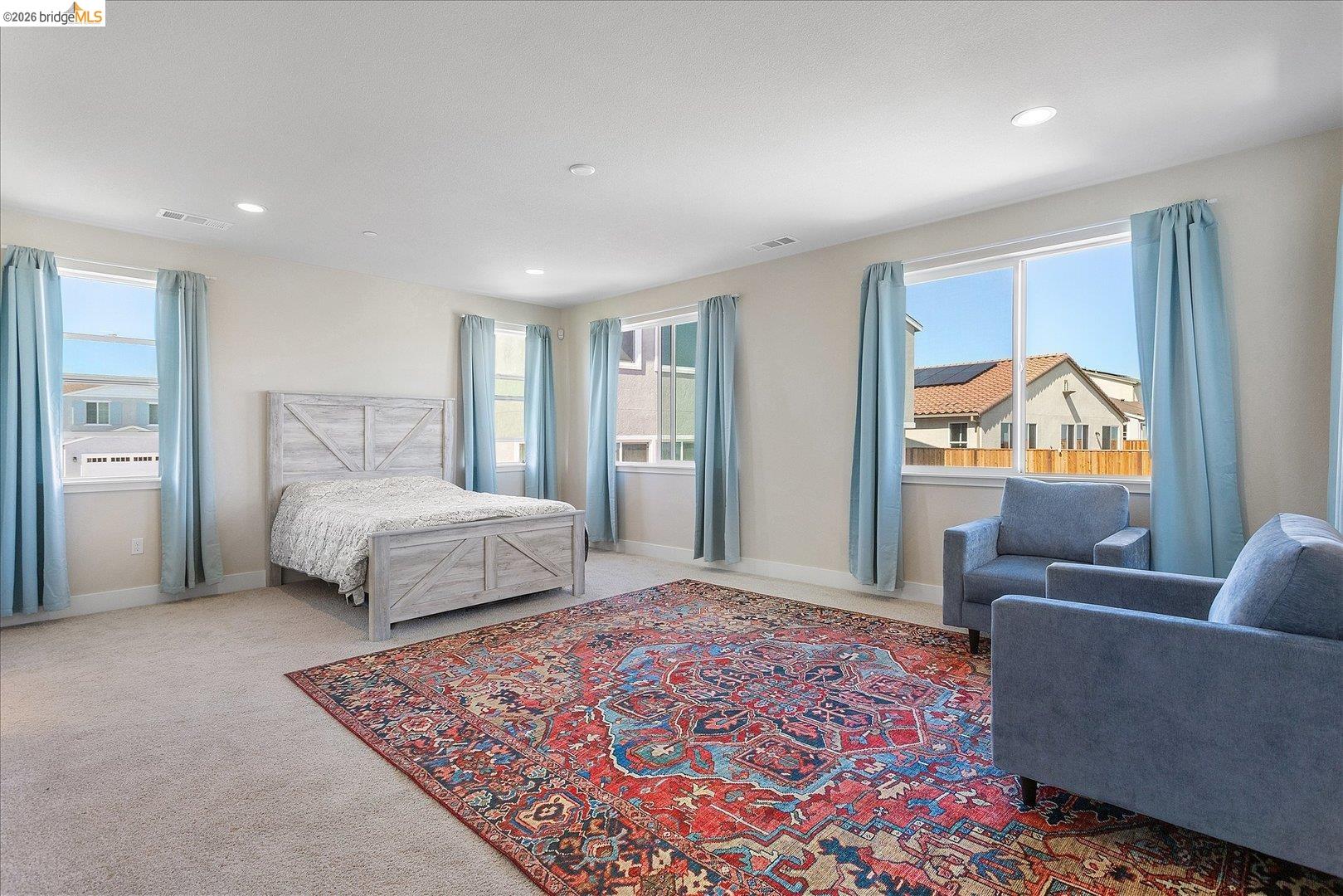 5601 Ridgepoint Way Antioch, CA 94531 - Photo 35 of 59 Spacious room featuring neutral carpeting, multiple windows with light blue drapery, and recessed lighting