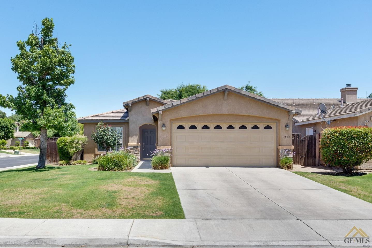 Undisclosed Address Bakersfield, CA 93311 - Photo 1 of 39 a front view of a house with a yard and garage