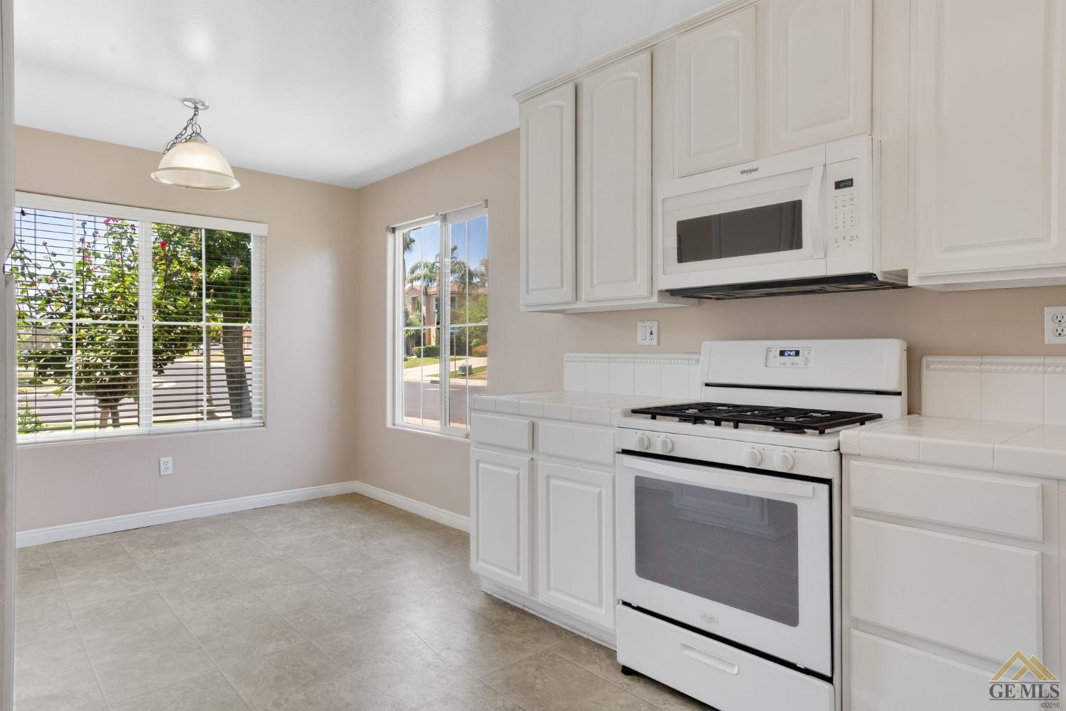 Undisclosed Address Bakersfield, CA 93311 - Photo 11 of 39 a kitchen with stainless steel appliances granite countertop white cabinets and a stove