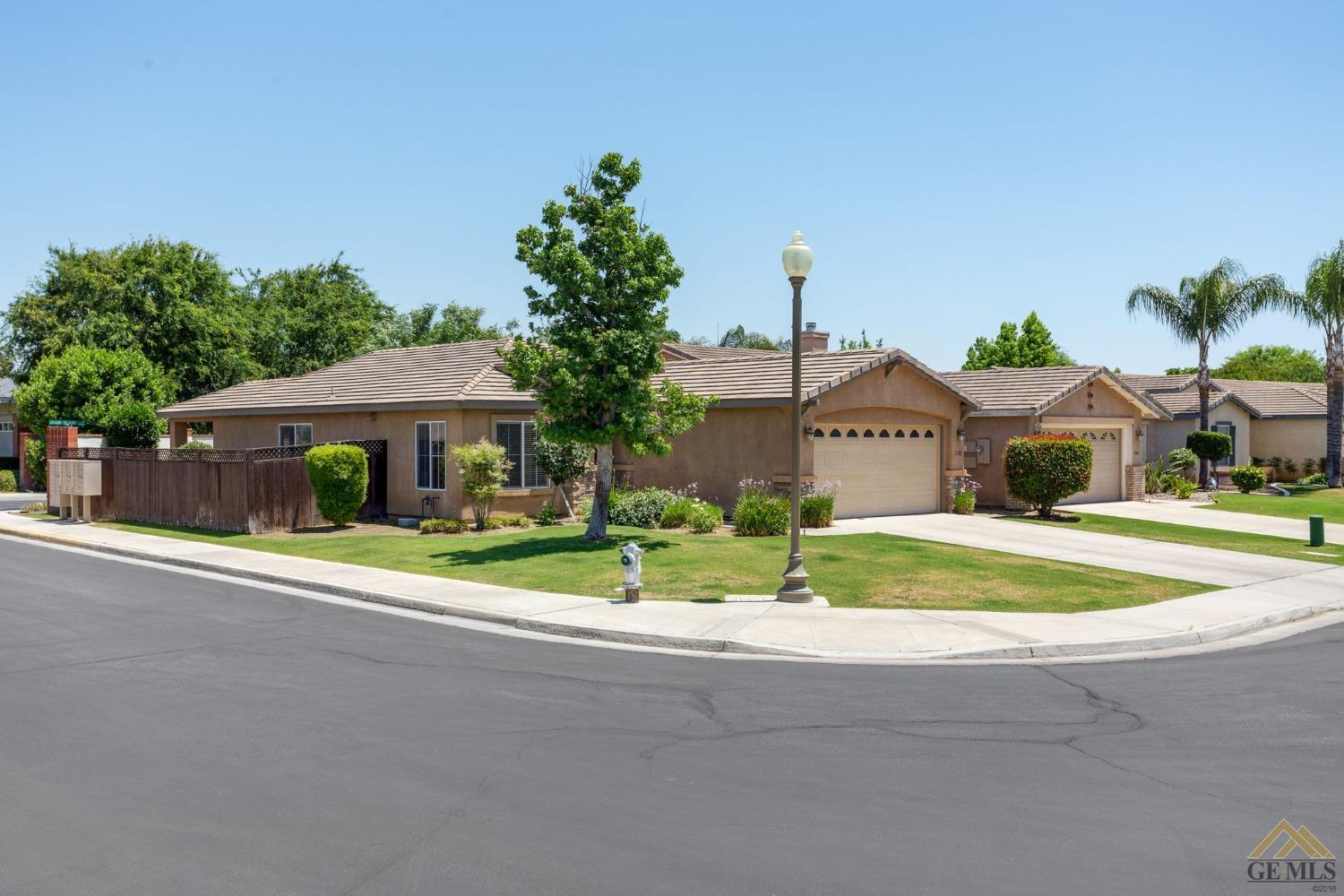 Undisclosed Address Bakersfield, CA 93311 - Photo 2 of 39 a front view of a house with a yard and trees